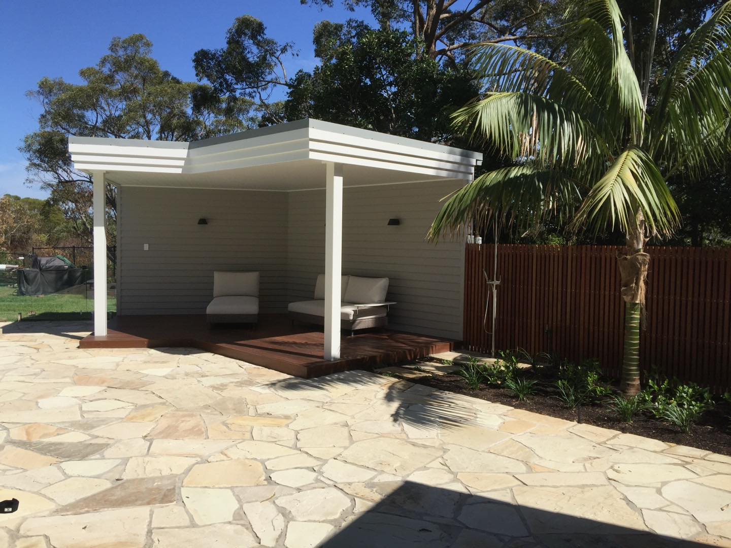 Whitewashed skillion pavilion over hardwood deck and crazy-paved sandstone patio