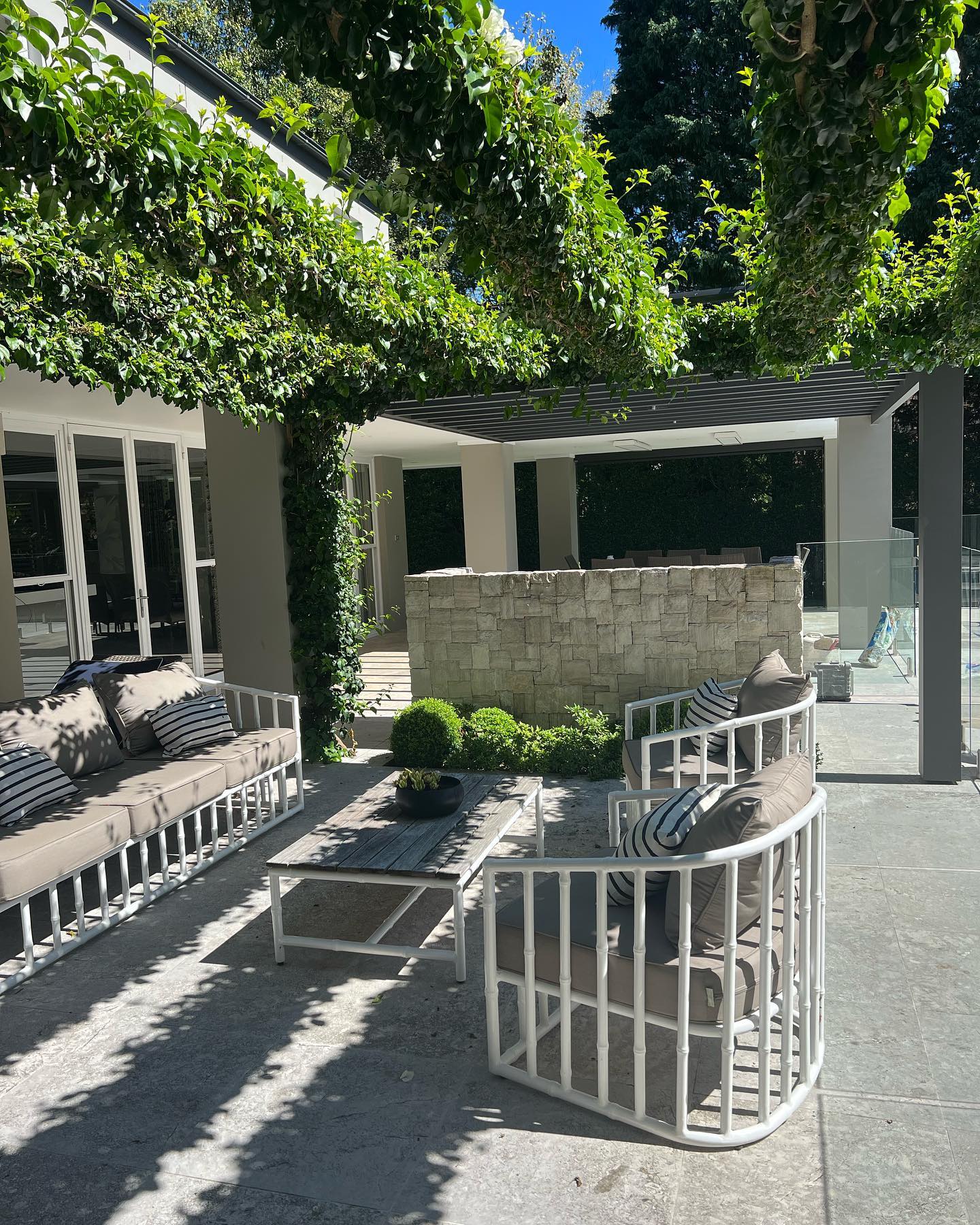 Wide view of a completed Townsend garden with sandstone walls and native grasses