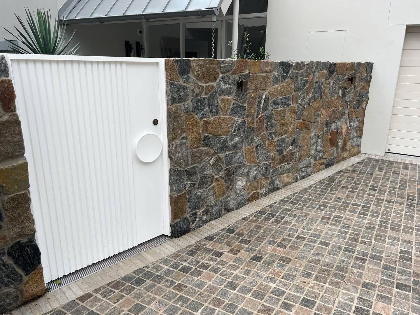 Freshly built sandstone retaining wall with concrete steps